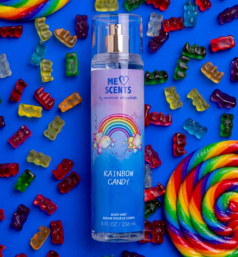 The Rainbow Candy Body Mist displayed alongside sugary sweets such as gummy bears and lollipops.