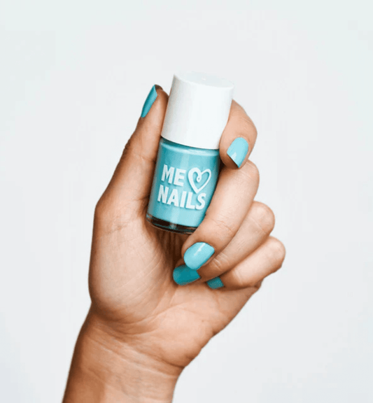 A hand holds the Serene Sky nail polish while showcasing nails painted in the same shade.







